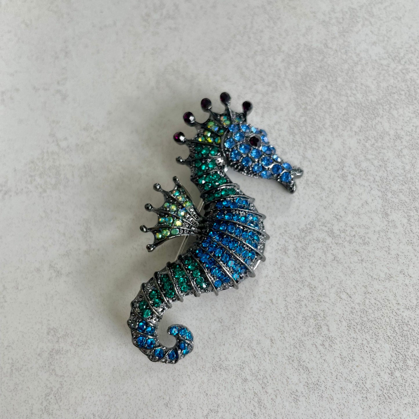 Green and blue seahorse pin brooch