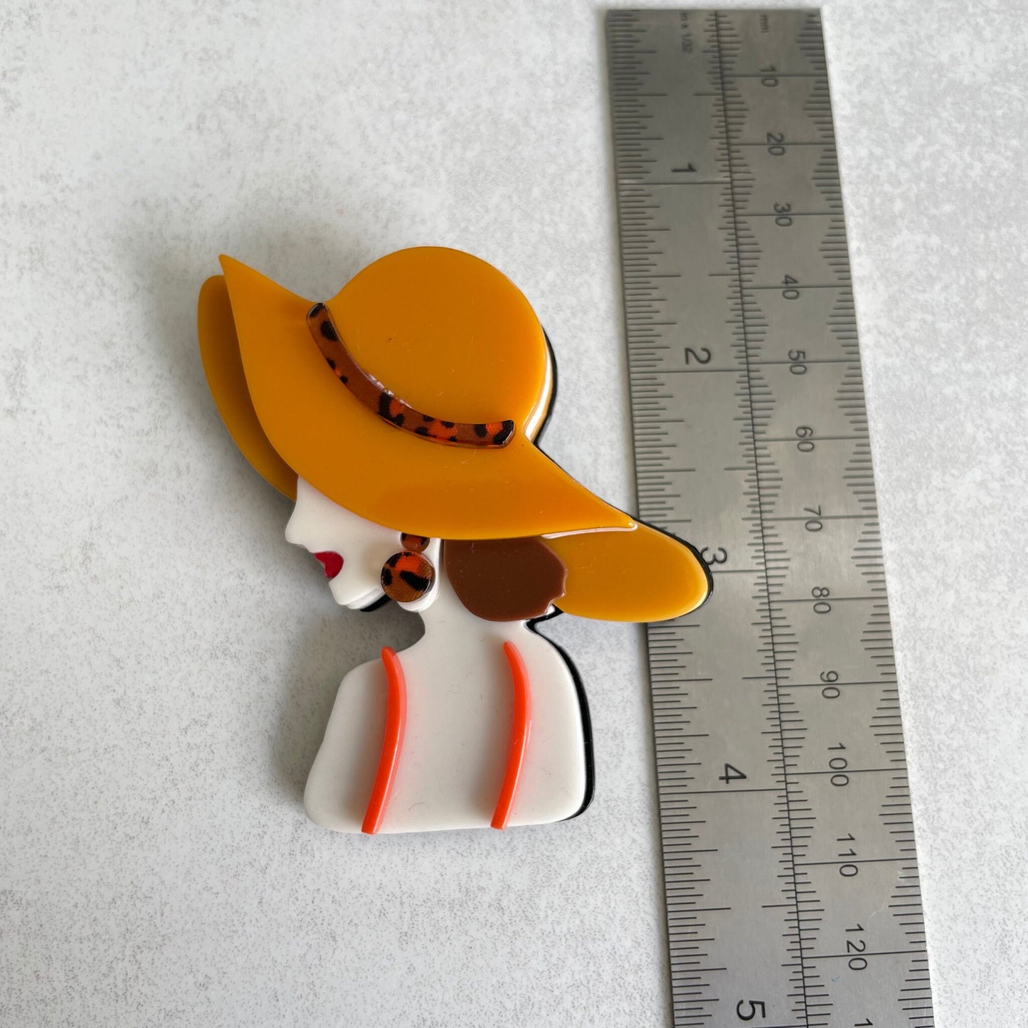 Art Deco lady with orange hat acrylic pin brooch