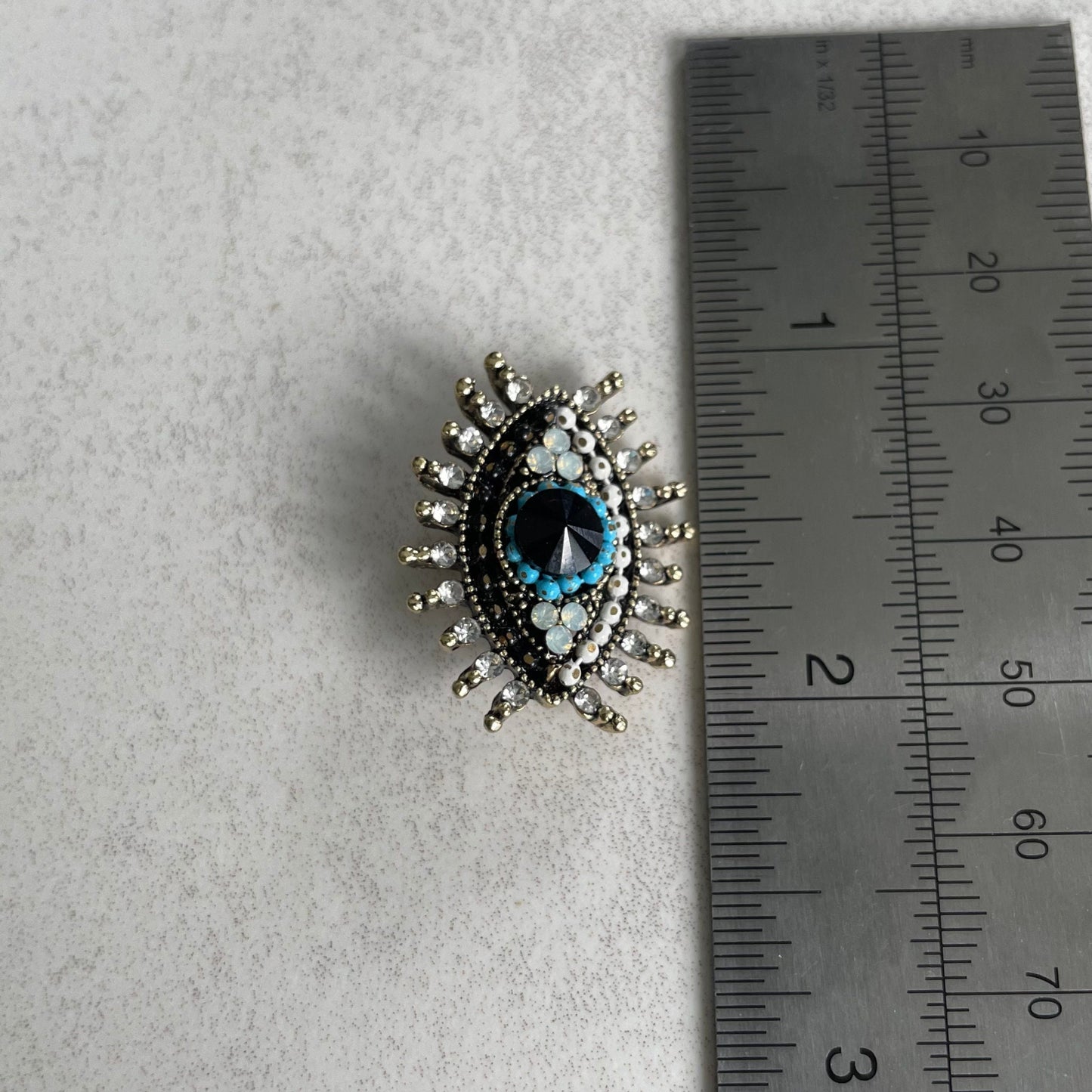 Small blue evil eye gold pin brooch