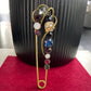 Vintage style blue sapphire safety pin gold brooch