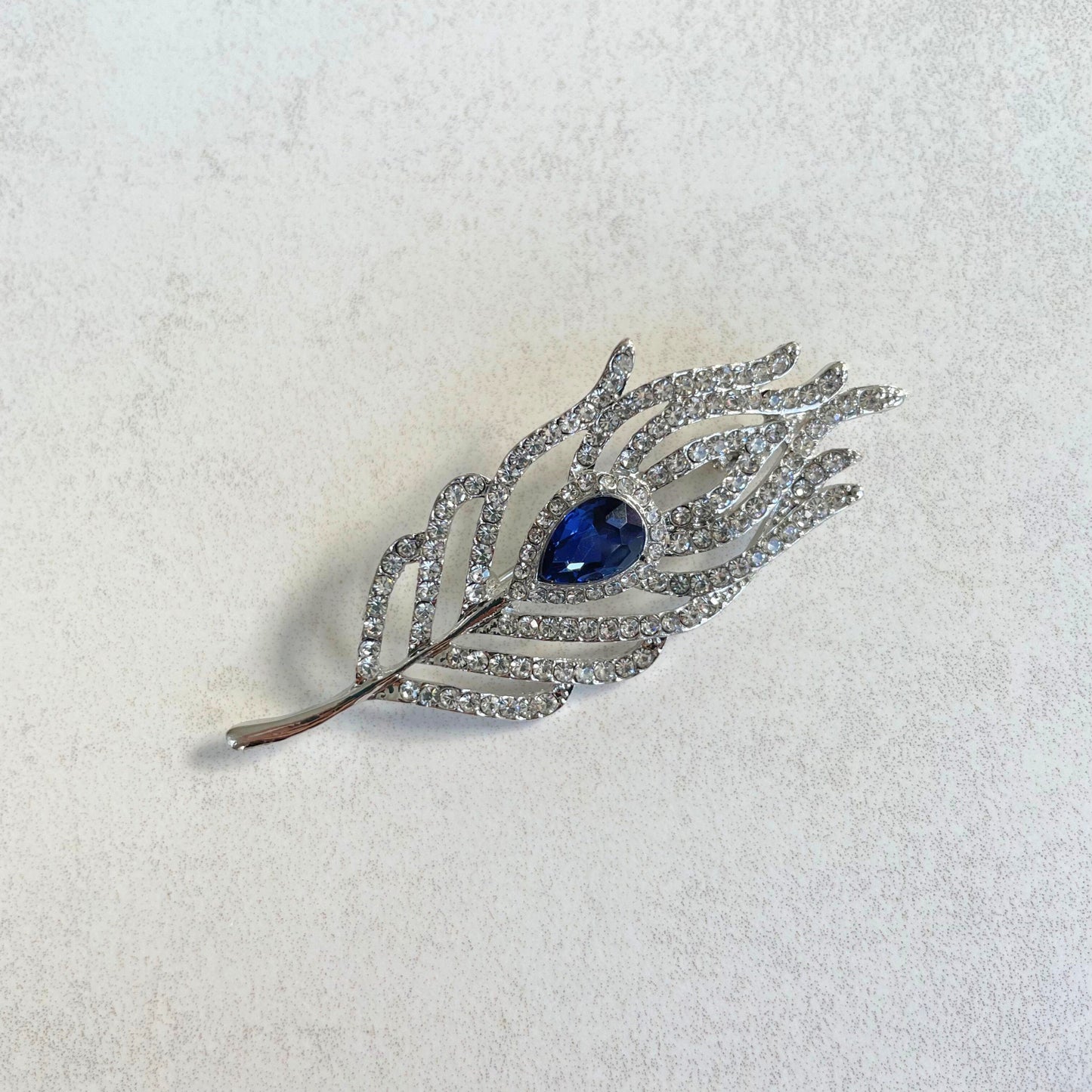 Delicate blue sapphire feather silver pin brooch