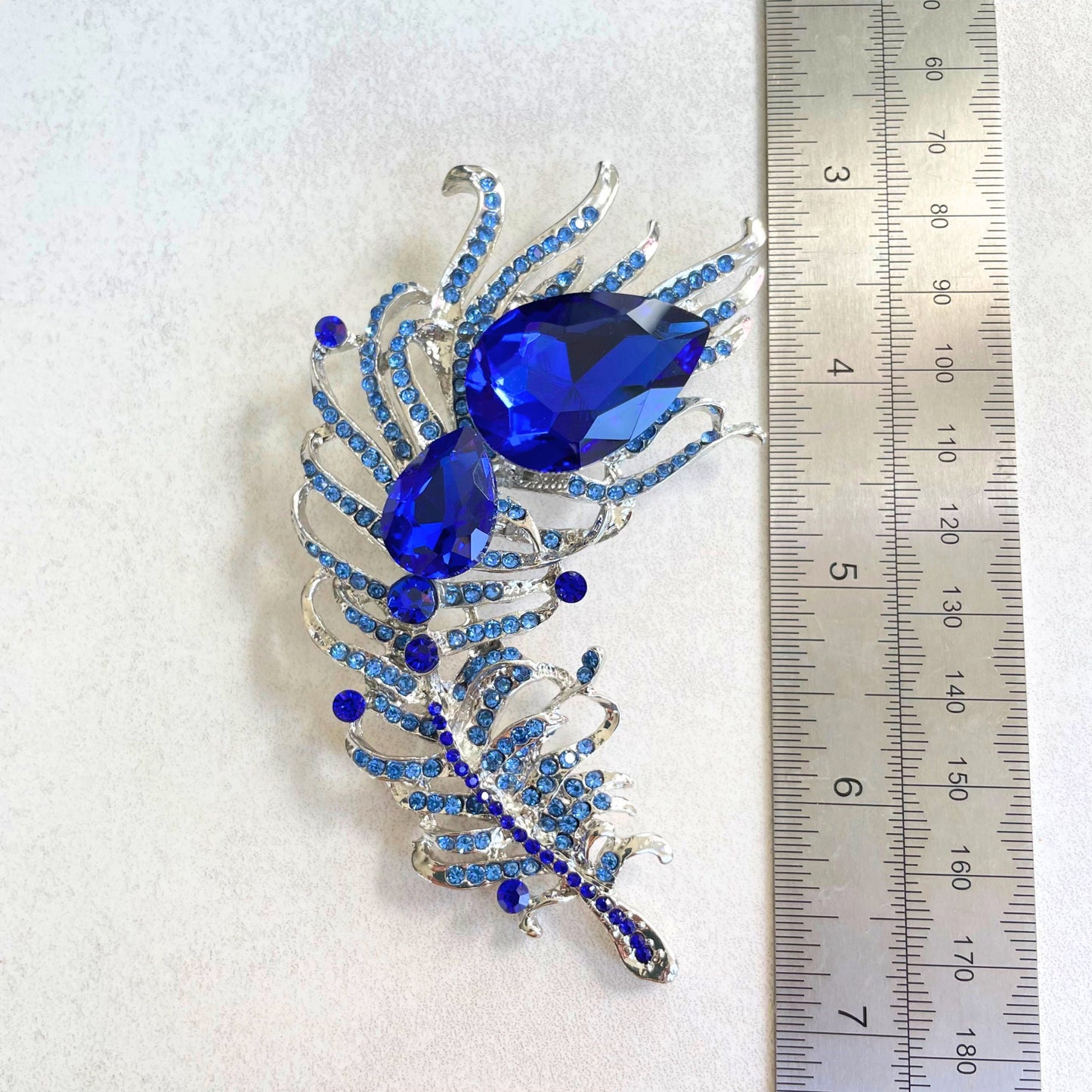 Statement sapphire feather silver pin brooch