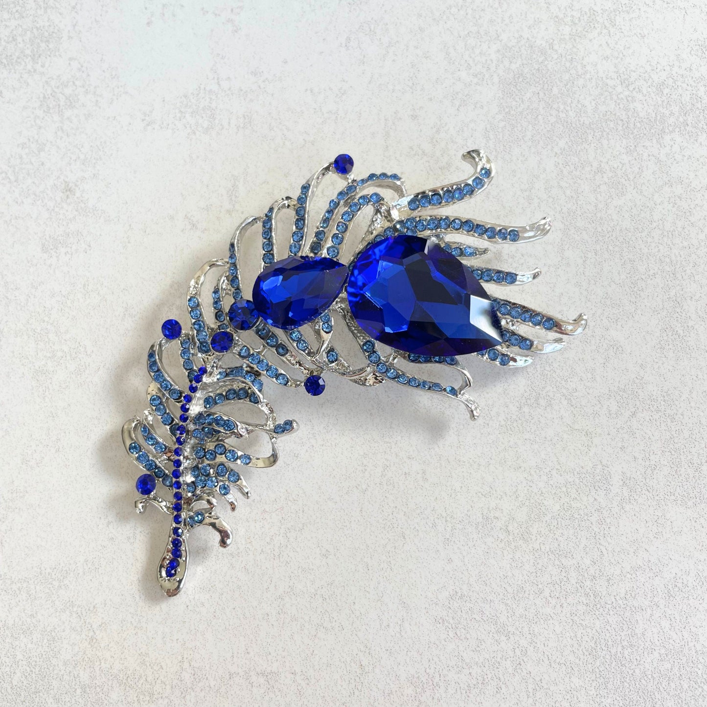 Statement sapphire feather silver pin brooch