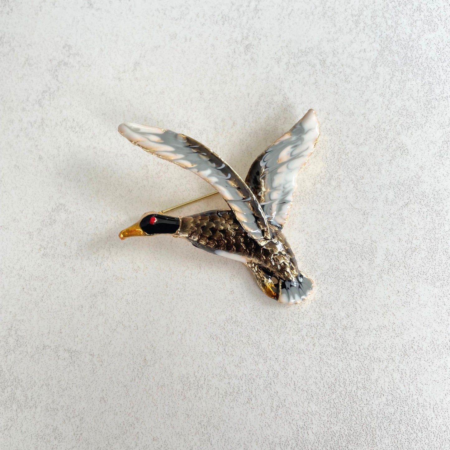 Enamel flying duck gold pin brooch