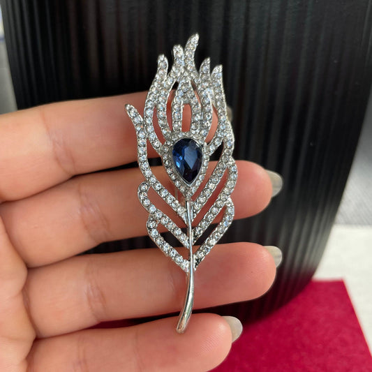 Delicate blue sapphire feather silver pin brooch